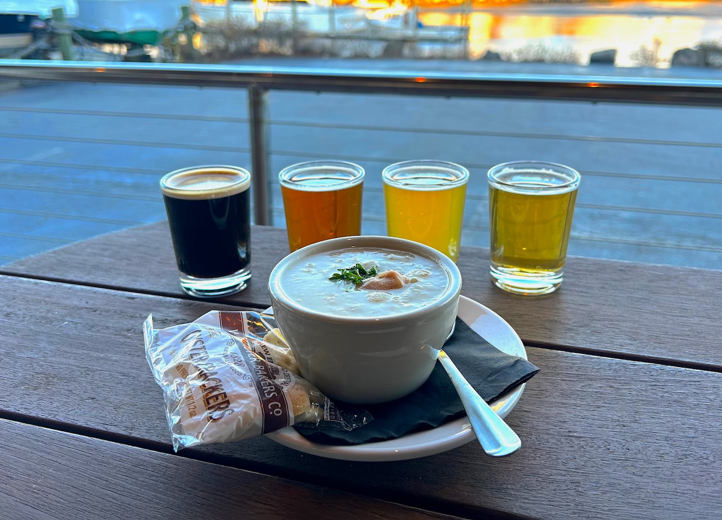A flight of craft beers sits beside a warm soup, highlighting Maine’s coastal flavors. - Portland, Maine