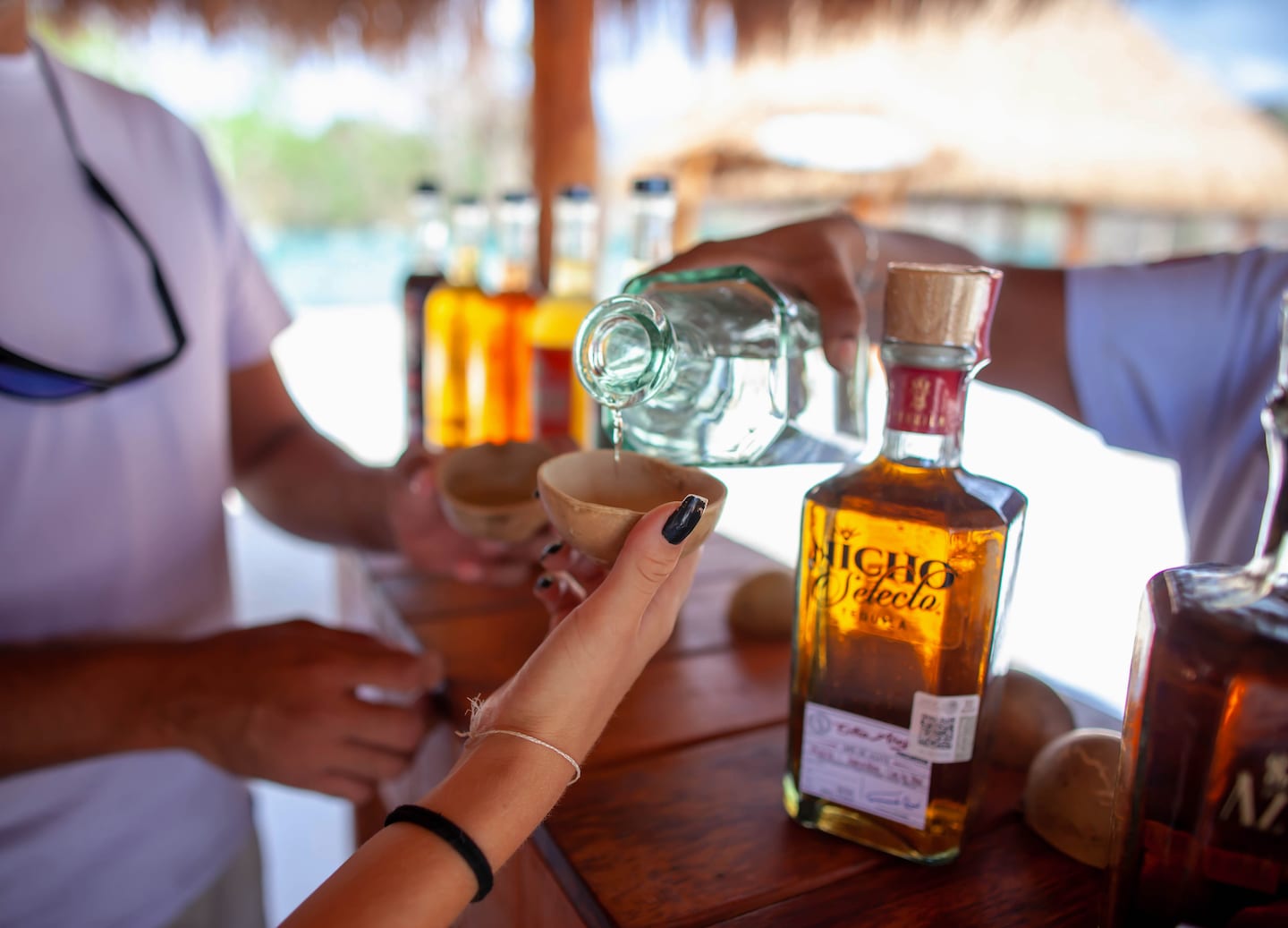 Tequila sample being poured into a cup. - Puerto Costa Maya, Mexico