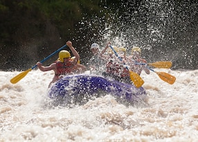 a group of men and women with a guide white water rafting on the patate river ecuador