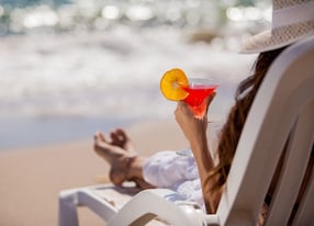 woman lounge chair drink cocktail beach