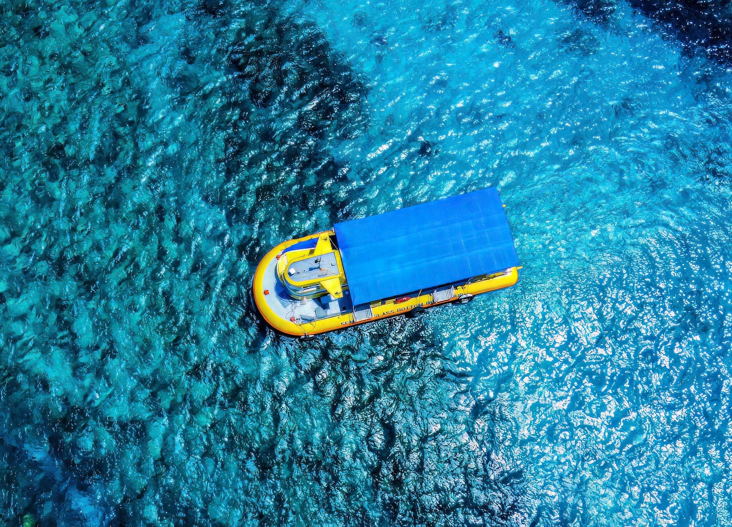 A semi‑sub glass‑bottom boat cruises along Roatán’s coast, revealing vibrant coral and tropical fish below. - Roatán, Honduras