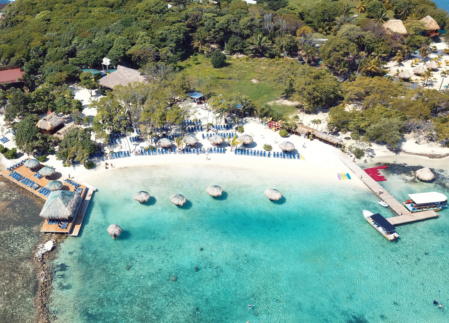 Guests swim above clear turquoise water near Big French Key, surrounded by bright coral and fish. - Roatán, Honduras