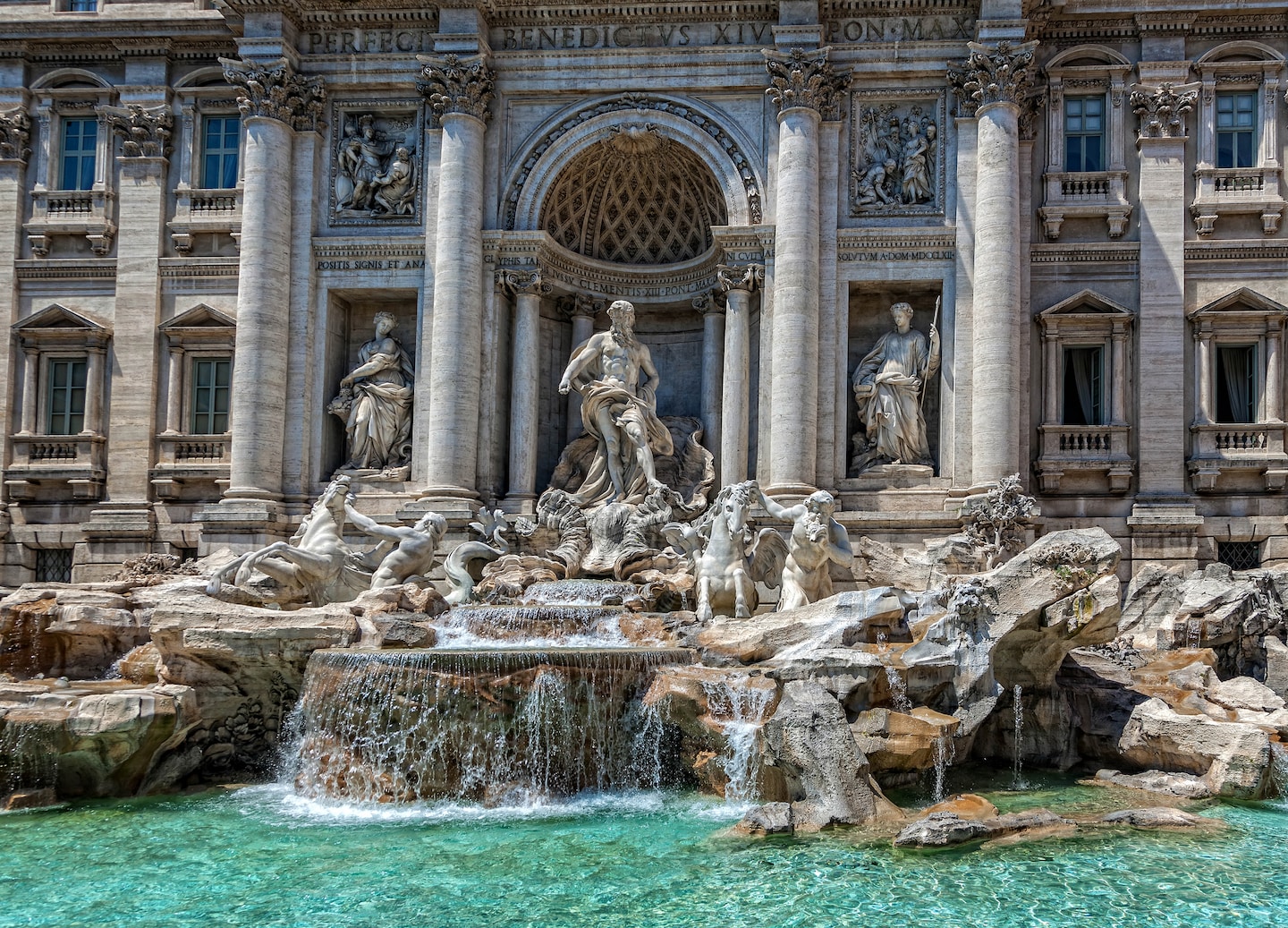 Trevi Fountain’s sculpted figures above turquoise water. - Rome, Italy