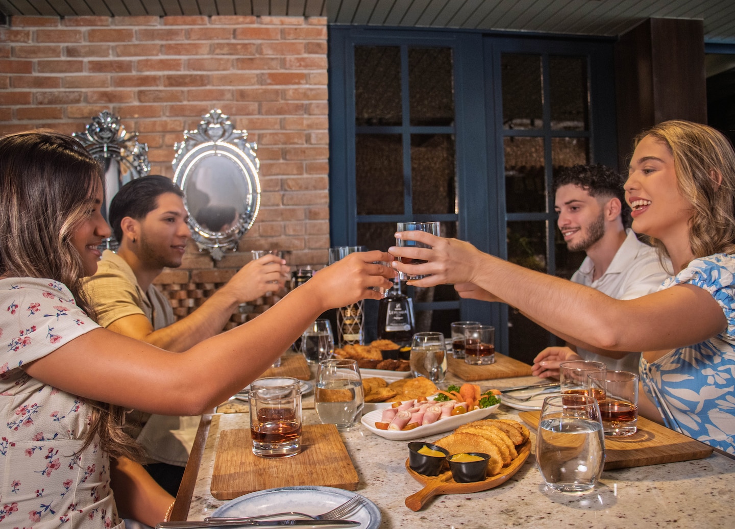 Friends share Dominican rum and snacks during a relaxed tasting stop. - Samaná, Dominican Republic