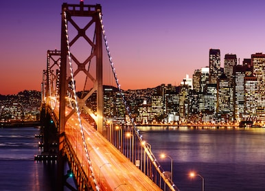 san francisco skyline and bay bridge at sunset california