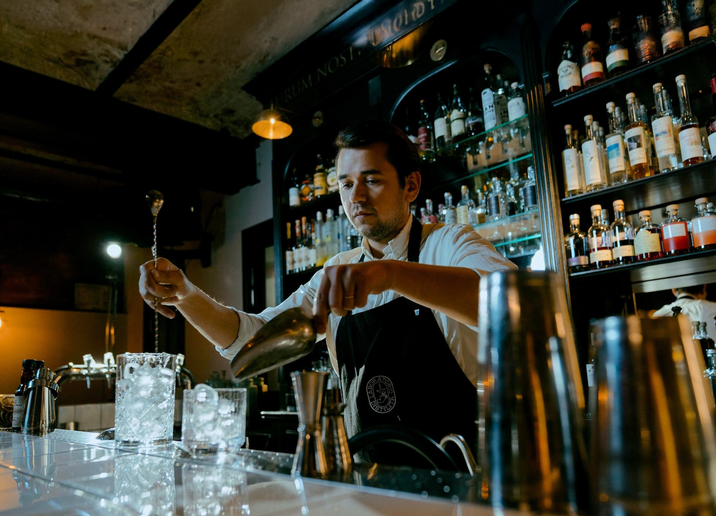 A bartender pours a crafted cocktail during a speakeasy‑style evening experience in Old San Juan. - San Juan, Puerto Rico