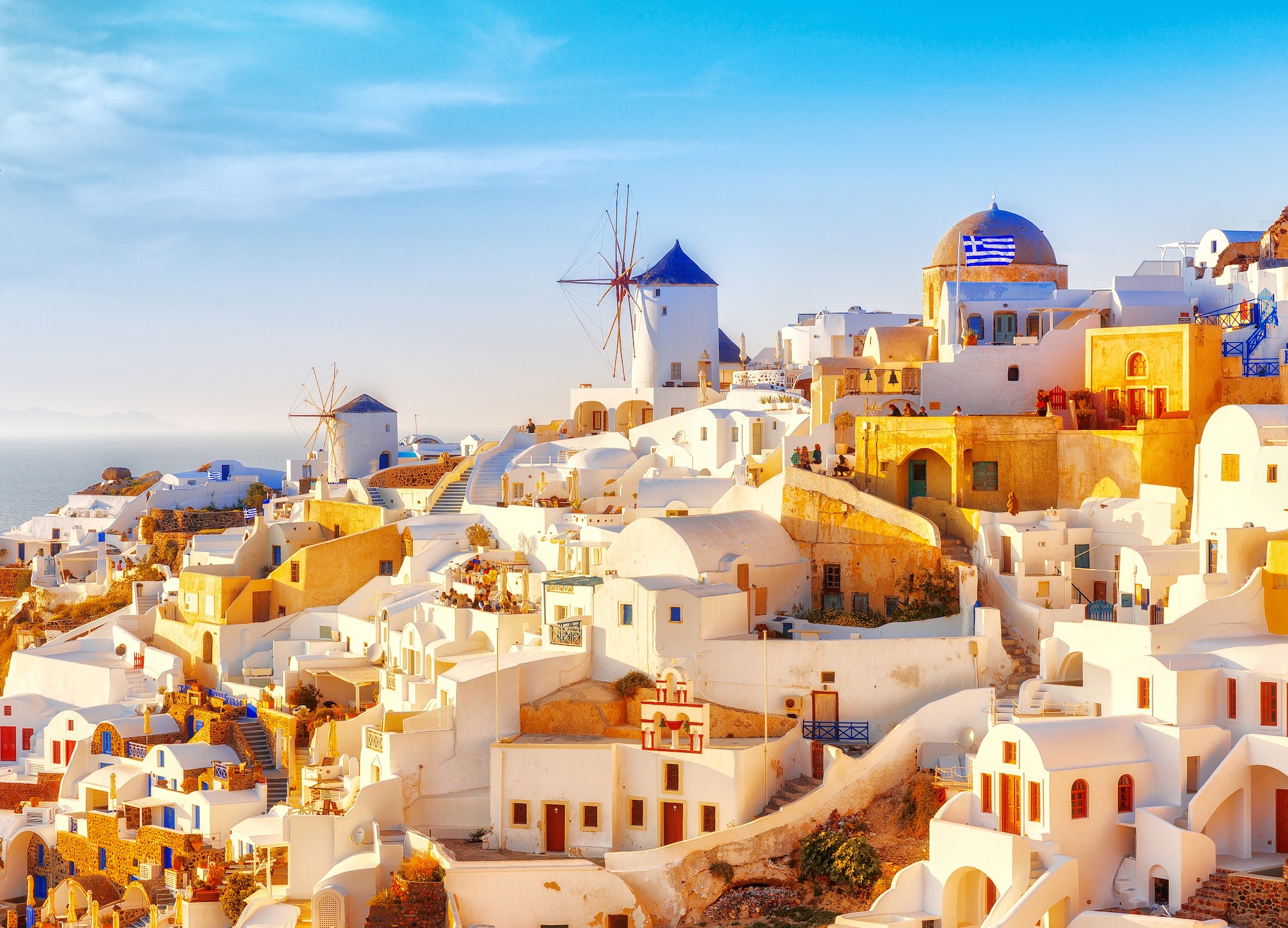 skyline of oia traditional white architecture with windmills greek village of santorini greece