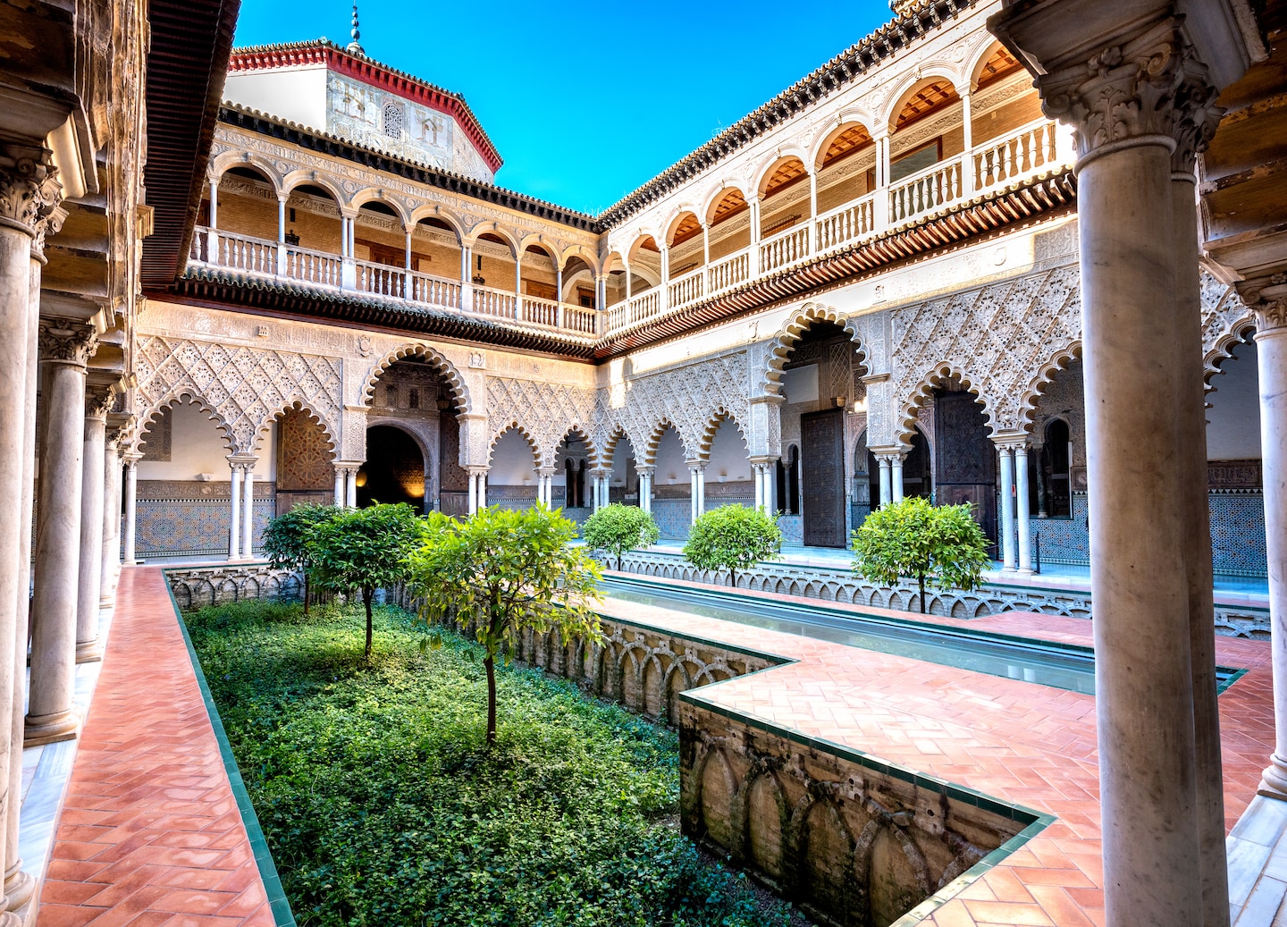 The Alcázar of Seville dazzles with Moorish architecture, ornate courtyards, and serene royal gardens. - Seville, Spain