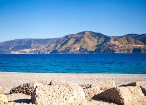 panoramic top view on sicilian torre faro beach and mediterranean sea bay from coastline between