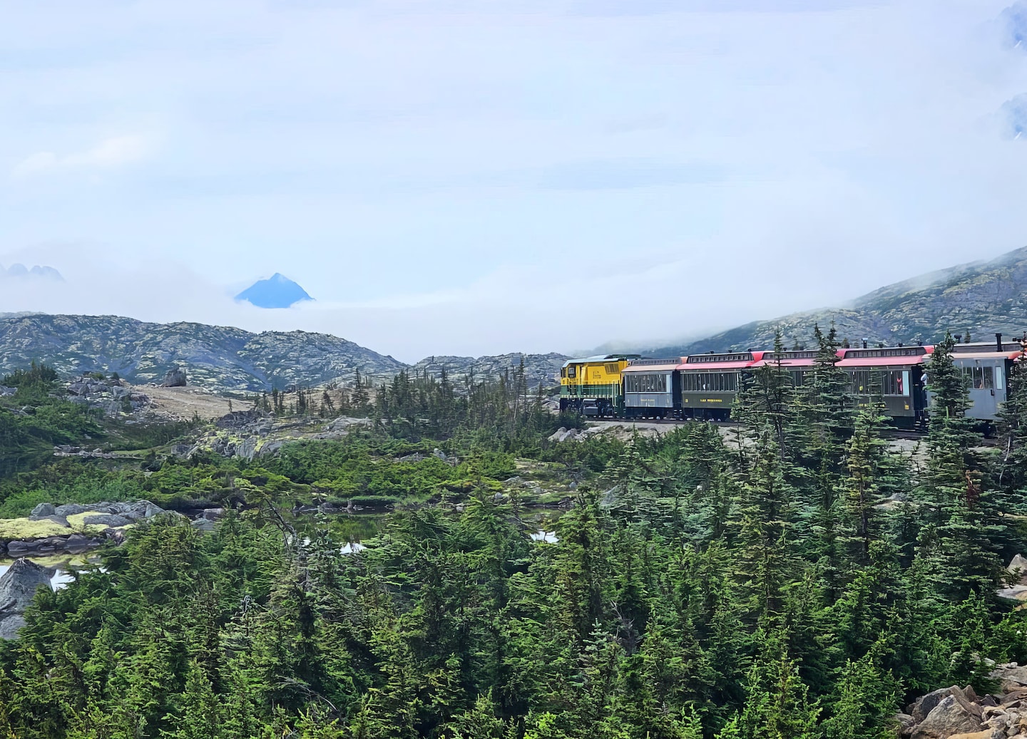 Train crosses canyon beside Yukon Suspension Bridge in Skagway. - Skagway, Alaska