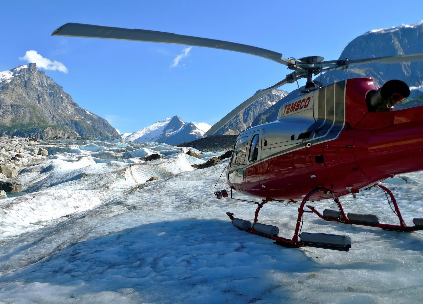 Helicopter rests on bright glacier. - Skagway, Alaska
