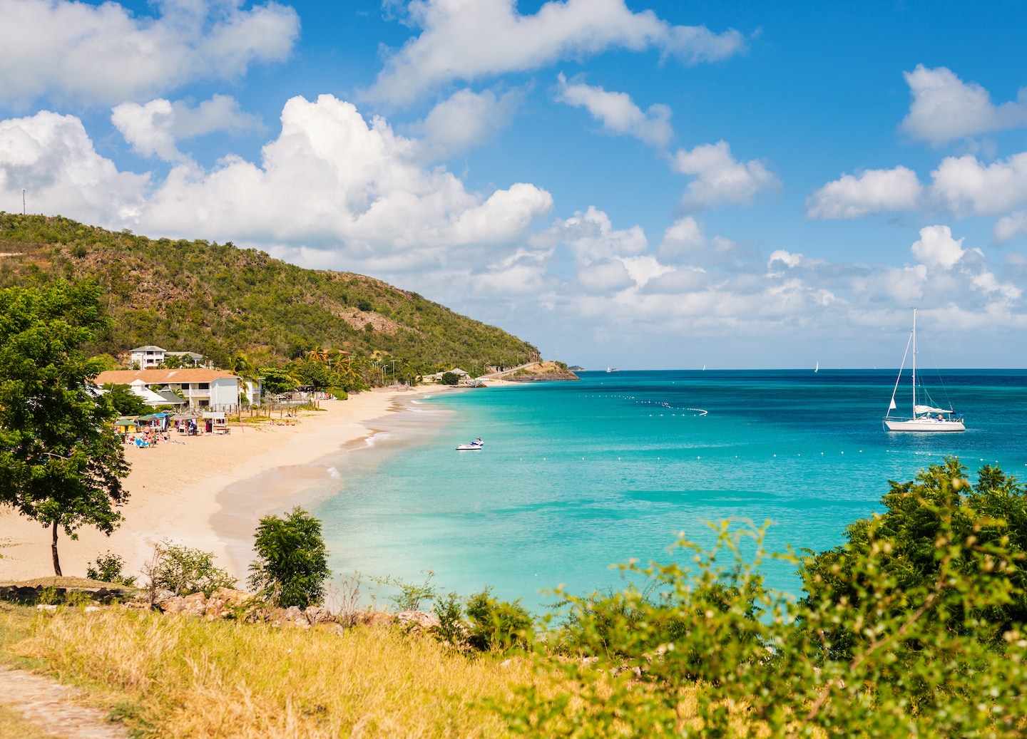 Catamaran sails along Antigua’s turquoise coastline. - Turner’s Beach, Antigua