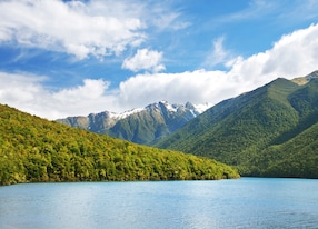 mountain ocean snowcap clouds