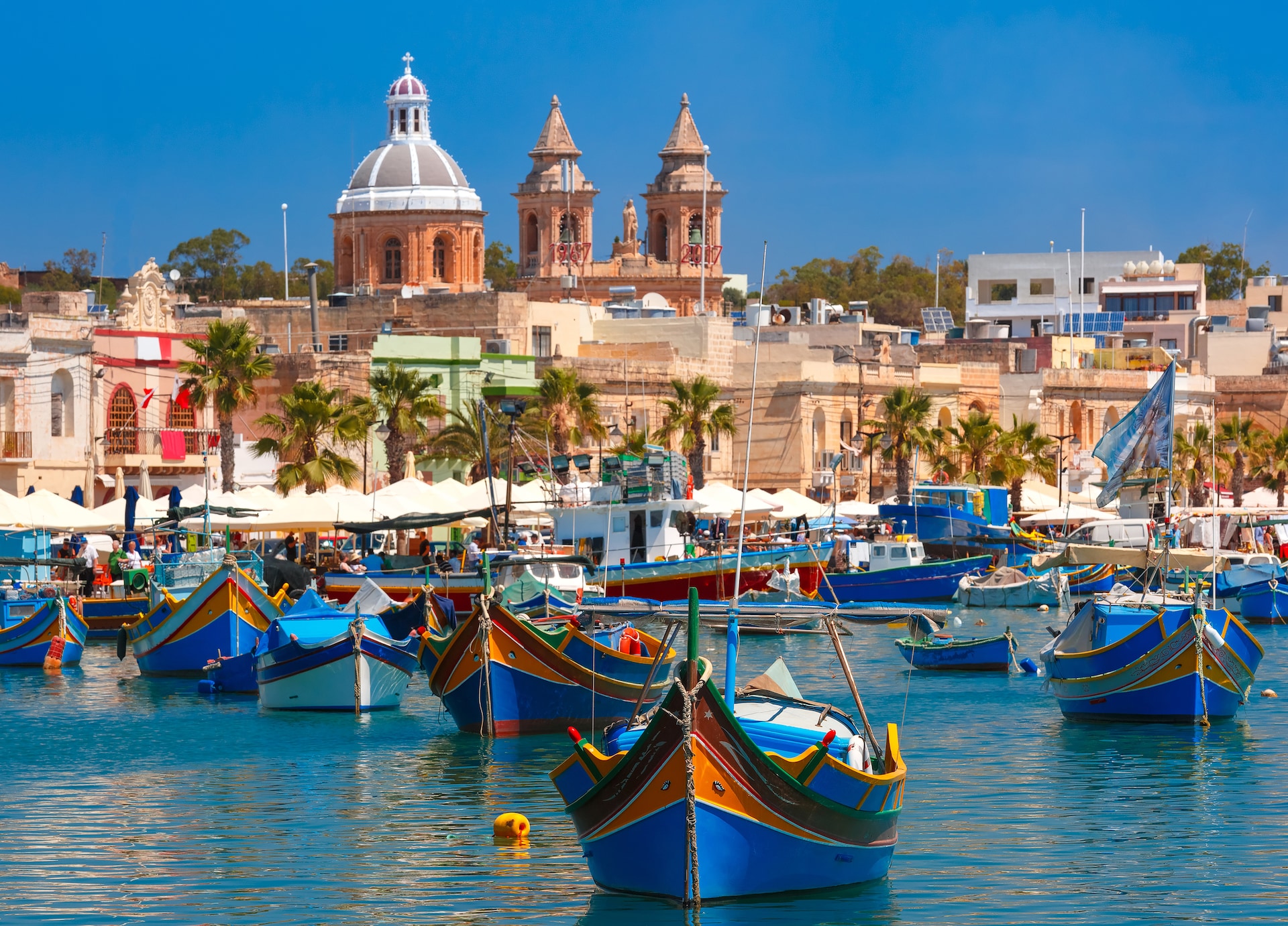 traditional eyed colorful boats luzzu in the harbor of mediterranean fishing village marsaxlokk