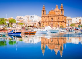 valletta malta msida marina boat and church reflection into water