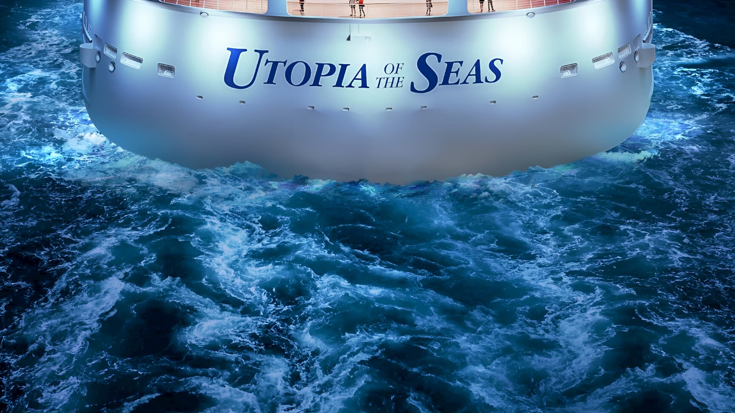 The back of a ship sailing through the water with the name Utopia of the Seas written across it. Utopia of the Seas.